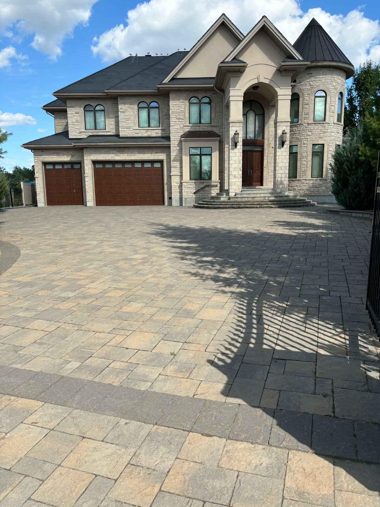 Luxury home with custom brown garage doors in Ottawa