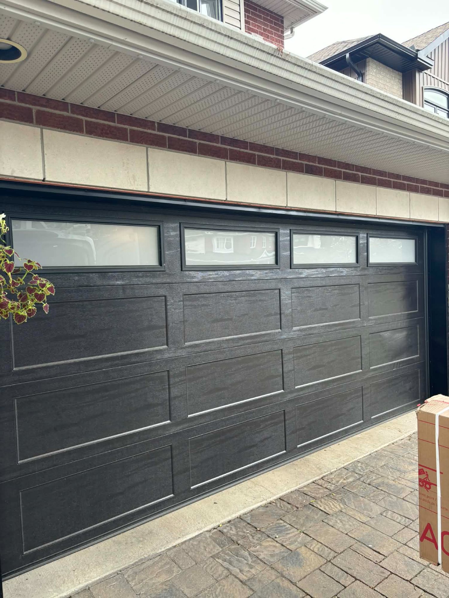 Modern black garage door with windows